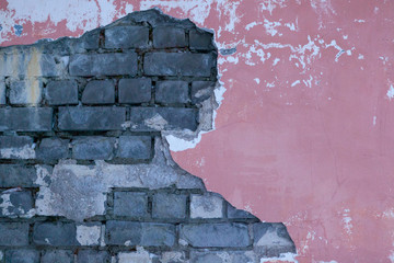 A dirty smudged red brick wall with the old paint