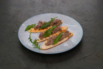 Croutons with paste and arugula. Festive appetizer, New Year's Italian dish