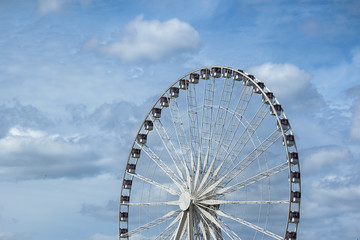 abstract background with ferris wheel on a background of blue sky with clouds