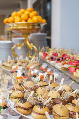 Mini burgers with meat and fish on the table prepared for the guests of the event.