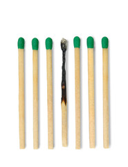 Six matches against white background. One burned. Difference concept