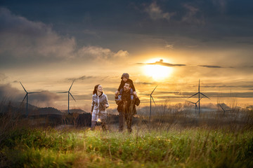 Happy family at sunset. father, mother and son having fun and playing in nature. the child sits on...
