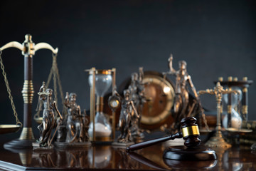 Obraz na płótnie Canvas Law theme. Gavel of the judge, Themis statue and scale of justice on gray background.