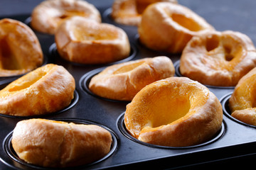 Yorkshire puddings in a metal baking tray