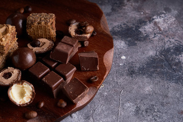 black and white chocolate, chocolates on a gray stone background Copy space Top view