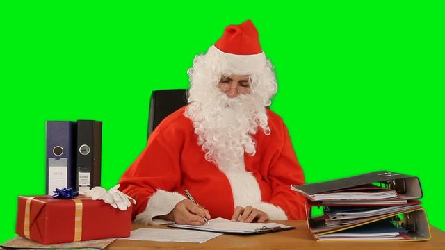 Santa Claus at his office writting a list of good and bad, Green Screen Chromakey