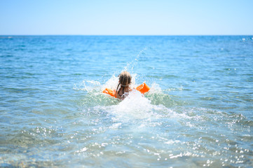 little girl having fun at summer vacation in sea