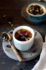 Berry flower tea on a dark wooden background