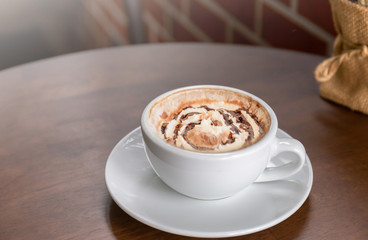 Hot chocolate in a white cup on table