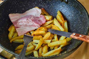 bacon with fried potato in pan