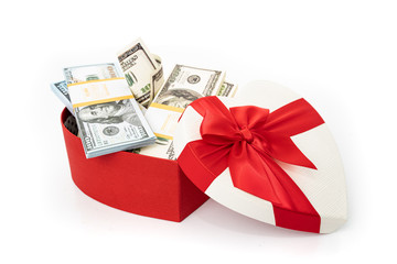 Bundle of dollars in heart gift box with bow isolated on white