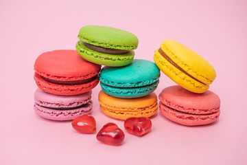 Fototapeta na wymiar French Colorful Macarons on Pink Background