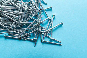 construction metal nails on blue background