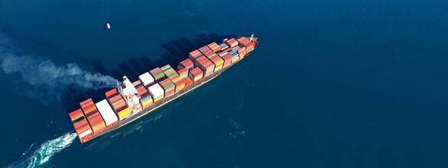 Aerial drone photo of industrial cargo container carrier cruising the open ocean deep blue sea