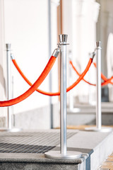 Fototapeta premium Posts for fencing the passage with a rope. Posts near the club, hotel, office building.