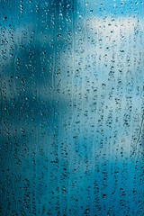 heavy rain drops on blue window