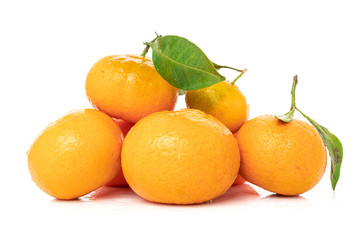 Fototapeta na wymiar Ripe mandarines with leaves close-up on a white background