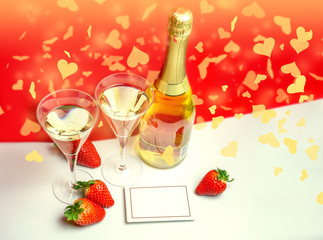 Two champagne glasses with strawberries and light shower copy space. Valentine's Day concept
