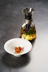 Fresh peeled chili tomatoes and minced cucumbers on dark background