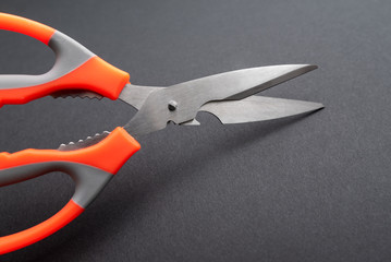 large kitchen metal scissors on black background