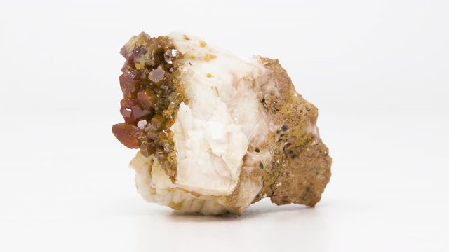 Extremely close view of Vanadinite crystals on Barite mineral. Rotating completely. Looping