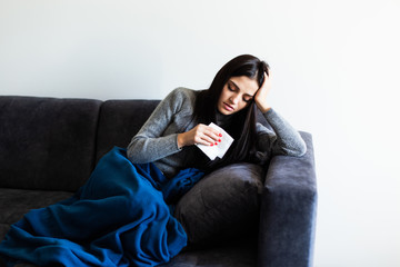 Fototapeta premium Sick woman, Flu woman. Caught Cold. Young beautiful woman with a throat pain feel sick in the couch