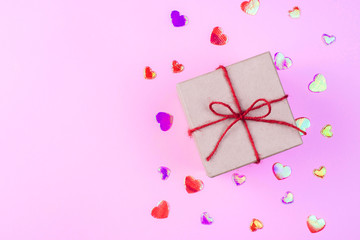 Valentine's day beautiful romantic background-craft box with red bow on pink background with hearts
