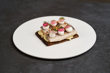 Smorrebrod with Baltic herring fish, smoked mousse and pickled onions