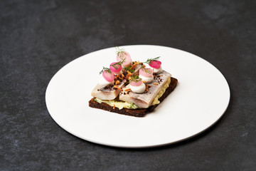 Smorrebrod with Baltic herring fish, smoked mousse and pickled onions