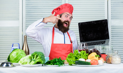 Culinary school. Hipster in hat and apron buy products online. Shopping online. Man chef searching...
