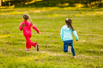 Summer fun. little girls play in the field