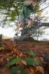 Man Riding Bike Through Forest