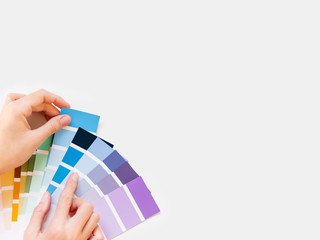 Woman holds rainbow color pallette on white background. Designer tool with copy space. Top view,...