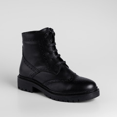 Classic black womens leather lace-up demi season boots. Studio photo for a catalog on a white background with shadows, close-up