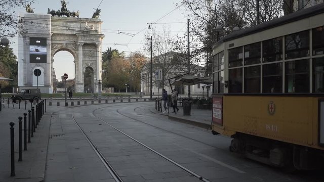 old vintage tram on the streets of Milan in Italy. Arco della Pace on the background.