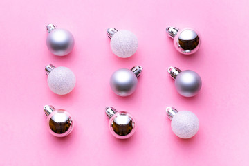 Xmas background. Christmas decoration balls isolated on pink. Abstract winter concept. Flat lay
