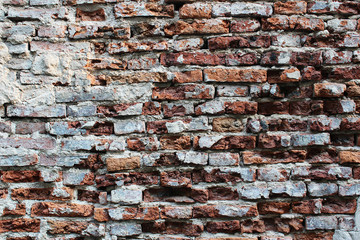 Red broken brick wall as a background