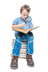 Cute boy reading a book with magnifying glass on a background.