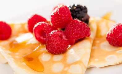 pancakes with raspberries, blackberries and honey