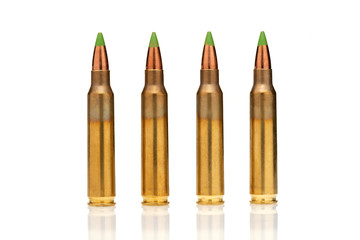 A group of 5.56 calibar, green tip bullets ordered into the line on white background