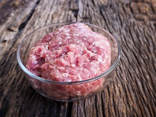 Raw minced pork on wood background