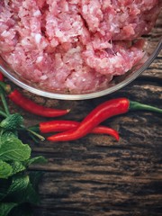 Raw minced pork on wood background
