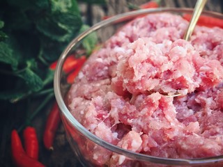 Raw minced pork on wood background