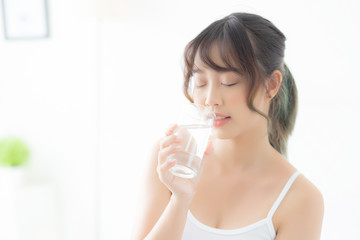 Beautiful portrait young asian woman caucasian smiling with nutrition thirsty and drinking glass of water mineral with fresh and happy, asia girl diet for healthy care and wellness, lifestyle concept.