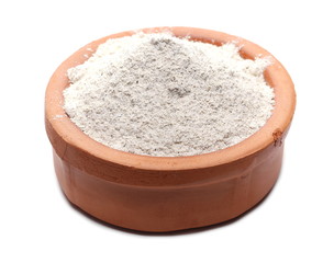 Buckwheat integral flour in clay pot, bowl isolated on white background 