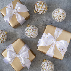 Christmas white balls and gold gift boxes.
