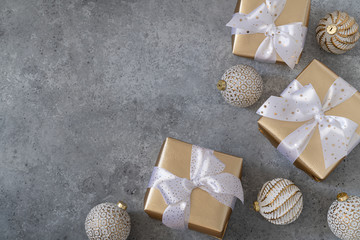 Christmas white balls and gift boxes on a grey background.