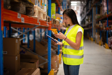 Workers in warehouse review the goods