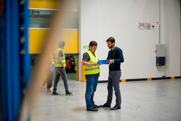 Warehouse staff meeting, workers with mnagers