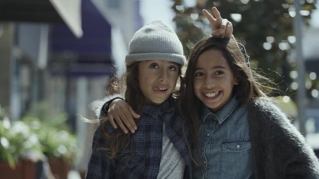 Portrait of silly boy and girl making faces in city / San Francisco, California, United States
